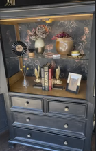 Load image into Gallery viewer, Dark wooden cabinet with decorative items on a floral-patterned background

