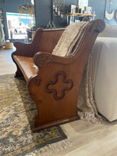 Load image into Gallery viewer, Wooden church pew with intricate carvings on a patterned rug
