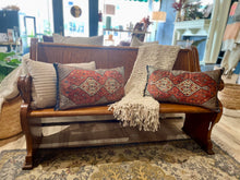 Load image into Gallery viewer, Wooden bench with decorative pillows and a blanket in a store setting
