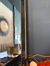 Load image into Gallery viewer, Close-up of a product with decorative elements on a dark background

