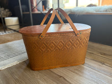 Load image into Gallery viewer, Woven picnic basket with a lid on a wooden floor
