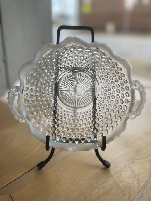 Clear glass dish with textured design on a wooden surface