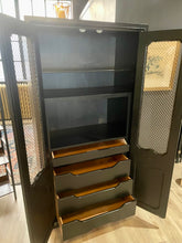 Load image into Gallery viewer, Tall black cabinet with open doors revealing shelves and drawers.
