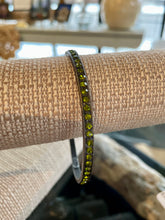 Load image into Gallery viewer, Olive green beaded bracelet on a textured surface with a blurred background
