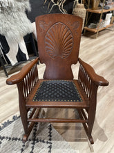 Load image into Gallery viewer, Wooden rocking chair with black quilted leather seat on a wooden floor.
