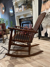 Load image into Gallery viewer, Wooden rocking chair in a room with a mirror and decorative elements.
