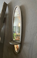 Load image into Gallery viewer, Oval wall mirror with decorative frame on a gray wall
