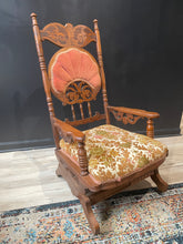 Load image into Gallery viewer, Wooden chair with pink and green cushion on a patterned rug
