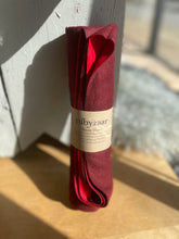 Load image into Gallery viewer, Red shawl with a label on a wooden surface
