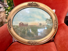 Load image into Gallery viewer, Decorative gold frame with a scenic view of a barn on a red cushion.
