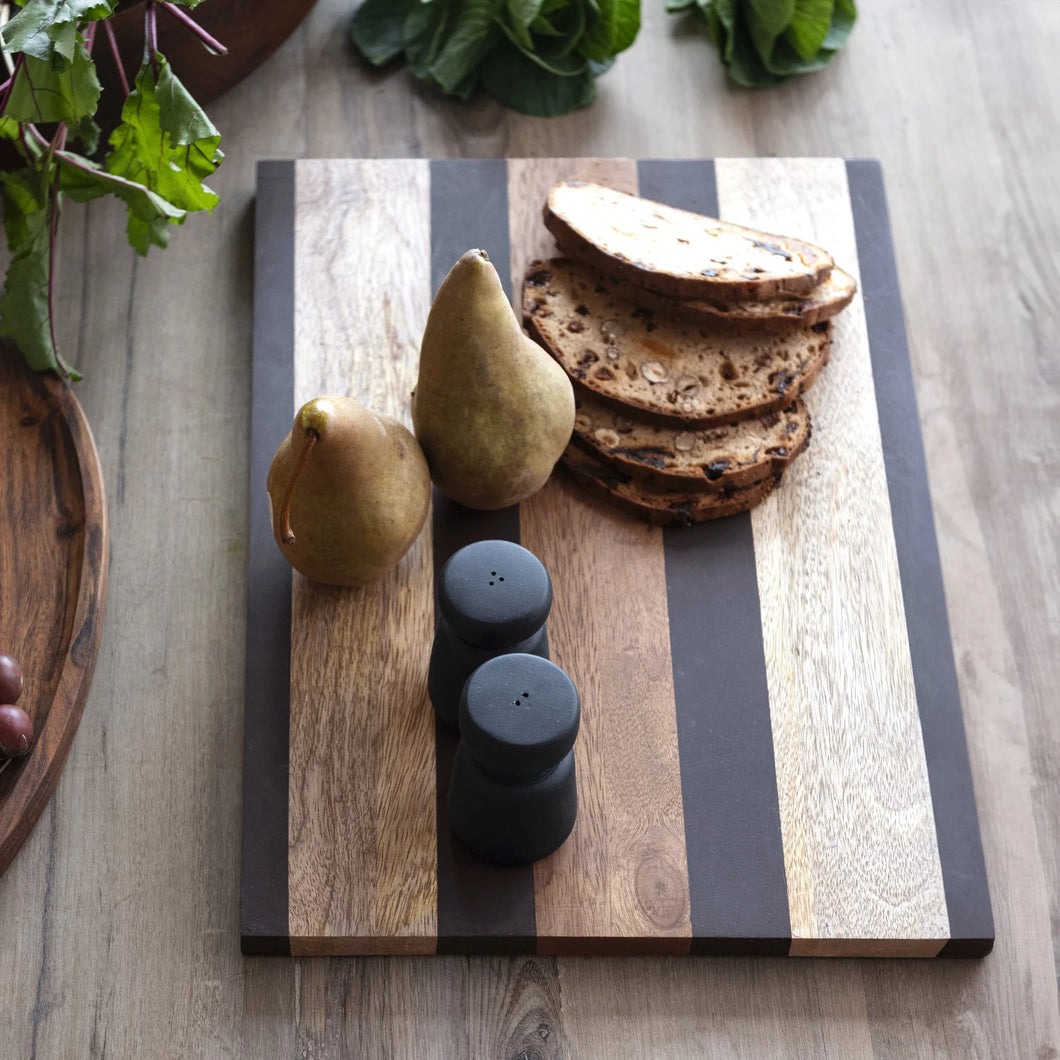 natural and black mango wood cheese and cutting board. Measures 16.75