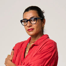 Load image into Gallery viewer, Woman wearing glasses and a red jacket with a neutral background

