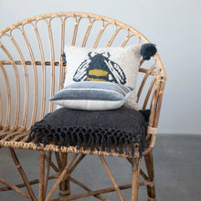 Load image into Gallery viewer, Wicker chair with decorative pillows on a plain background
