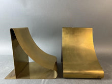 Load image into Gallery viewer, Two gold metal bookends on a gray background

