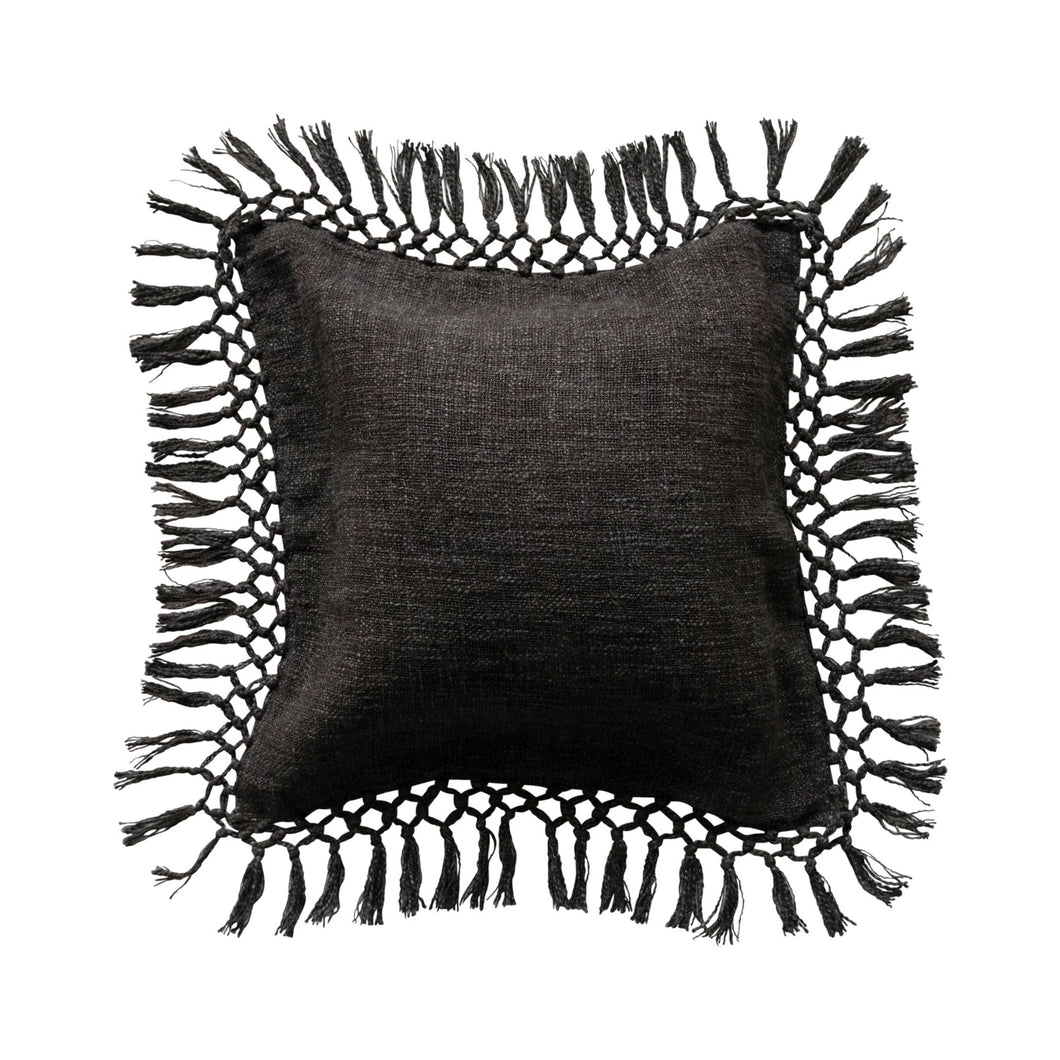 Black pillow with tassels on a white background