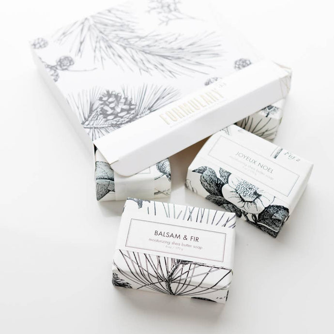 Packaged soaps with decorative boxes on a white background