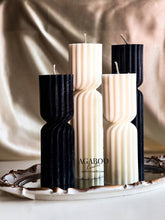 Load image into Gallery viewer, Three black and white candles on a decorative tray with 'AGABOO' branding.
