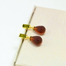 Load image into Gallery viewer, Pair of earrings with teardrop-shaped amber stones on a white background
