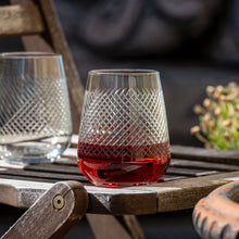Load image into Gallery viewer, Clear glass with red liquid on a wooden table outdoors
