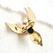 Load image into Gallery viewer, Gold ring with a black center on a white fabric background
