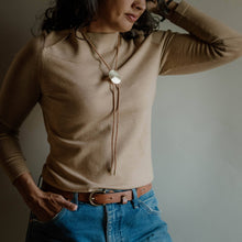 Load image into Gallery viewer, Brown braided leather rope tie with large brass disc bolo tie on a model
