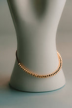 Load image into Gallery viewer, Gold beaded necklace on a mannequin bust against a neutral background
