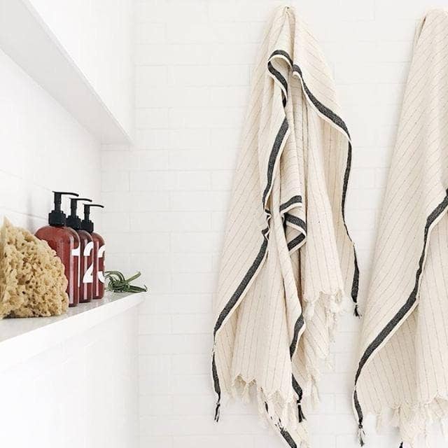 Silvia 100% Cotton Turkish Bath Towel in ivory with bold black stripe and light brown pinstripes.