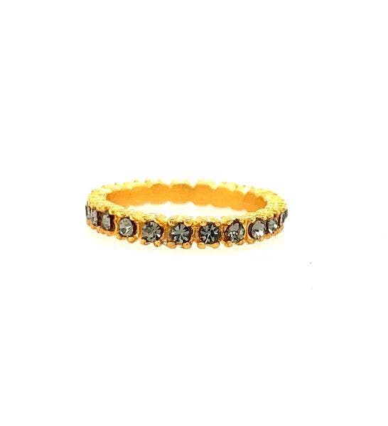 Gold ring with embedded stones on a white background