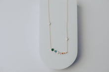 Load image into Gallery viewer, Necklace with colorful gemstones on a white surface
