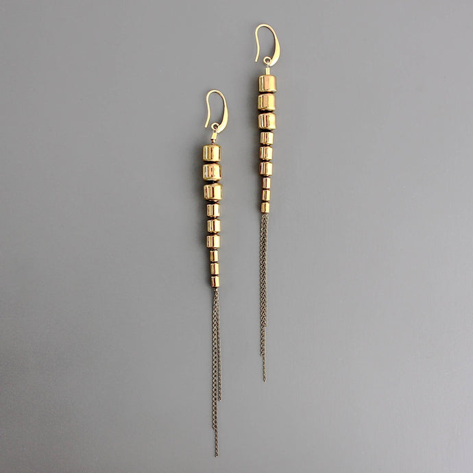 Gold brass beaded chain earrings on a gray background
