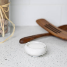 Load image into Gallery viewer, White ceramic bowl on a speckled countertop with a wooden spatula in the background.
