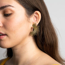 Load image into Gallery viewer, Close-up of a woman wearing a gold earring with a white background
