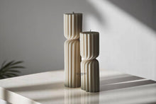 Load image into Gallery viewer, Two beige textured candles on a white surface with a blurred background
