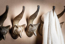 Load image into Gallery viewer, Wall with fox-shaped hooks and a white towel hanging on one of them.
