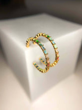 Load image into Gallery viewer, Gold hoop earrings with colorful  rainbow gemstones on a white surface
