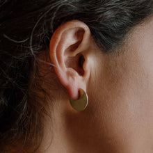 Load image into Gallery viewer, Close-up of an ear wearing a gold hoop earring with dark hair.
