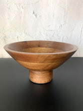 Load image into Gallery viewer, Wooden bowl on a dark surface with a light textured wall background
