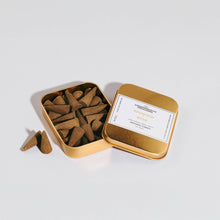 Load image into Gallery viewer, Open gold tin containing incense sticks with a visible label on a light gray background
