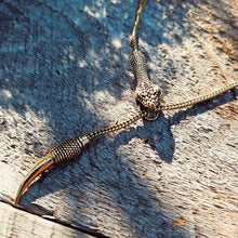 Load image into Gallery viewer, Solid brass serpant lariat necklace on a wooden surface
