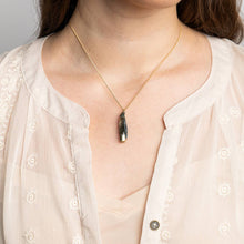 Load image into Gallery viewer, Gold necklace with a pendant worn by a person in a light blouse.
