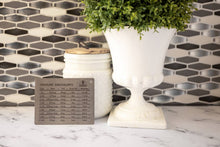 Load image into Gallery viewer, Decorative metal sign with measurement equivalents on a marble surface with a plant and jar in the background.
