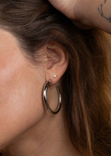 Load image into Gallery viewer, Woman wearing a silver hoop earring
