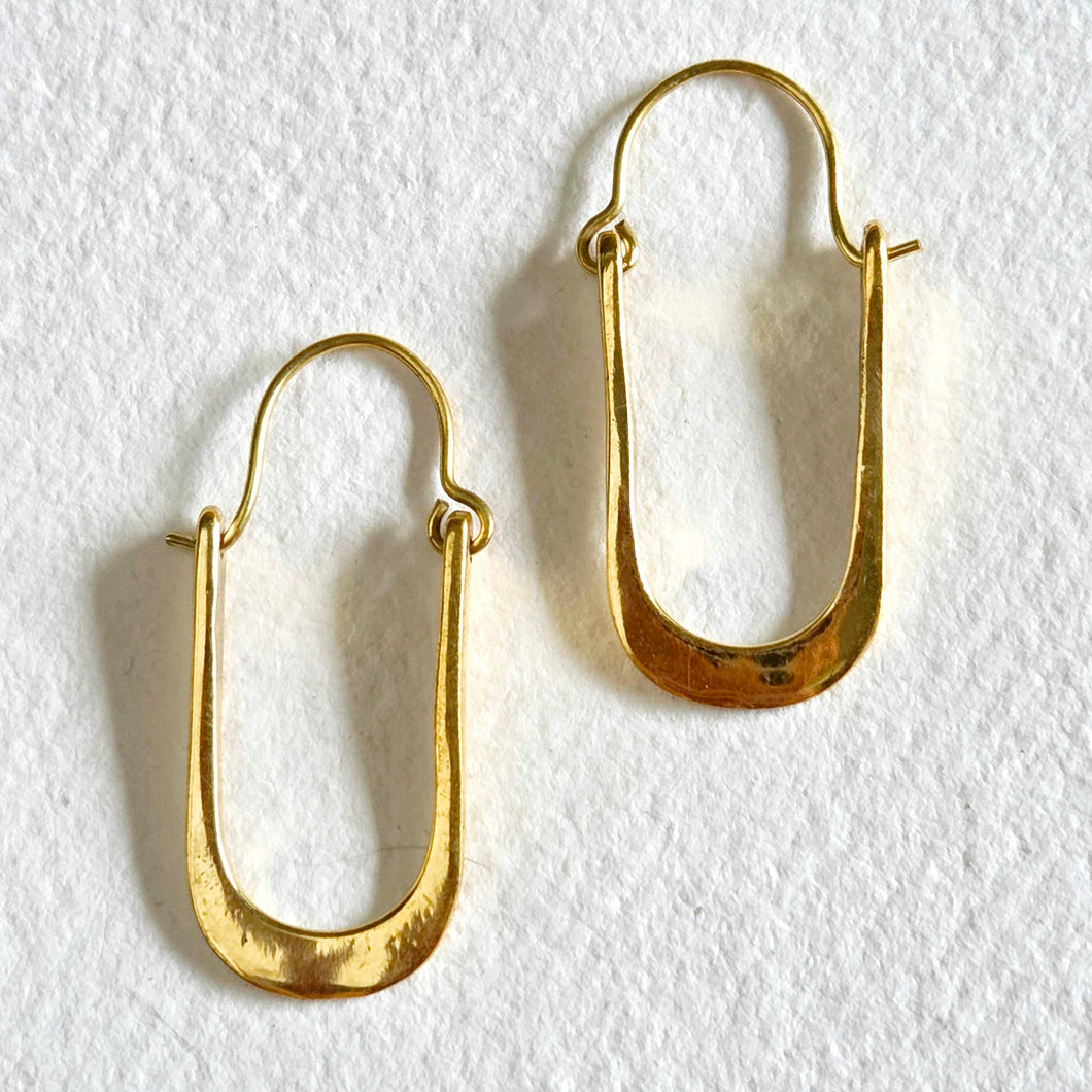 Gold hoop earrings on a white background