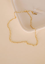 Load image into Gallery viewer, Gold chain necklace on a beige surface
