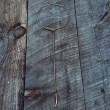 Load image into Gallery viewer, Solid brass serpant lariat necklace on wooden surface
