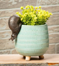 Load image into Gallery viewer, Ceramic snail-shaped planter with greenery on a wooden surface
