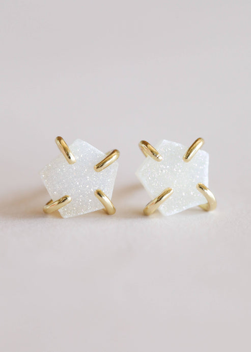 white druzy stone stud earrings secured with gold prongs