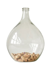 Load image into Gallery viewer, Clear glass bottle with wine corks collected at the bottom on a white background.
