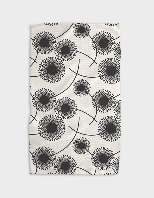 A white tea towel with a black floral pattern, featuring a single-sided print and a hang loop.